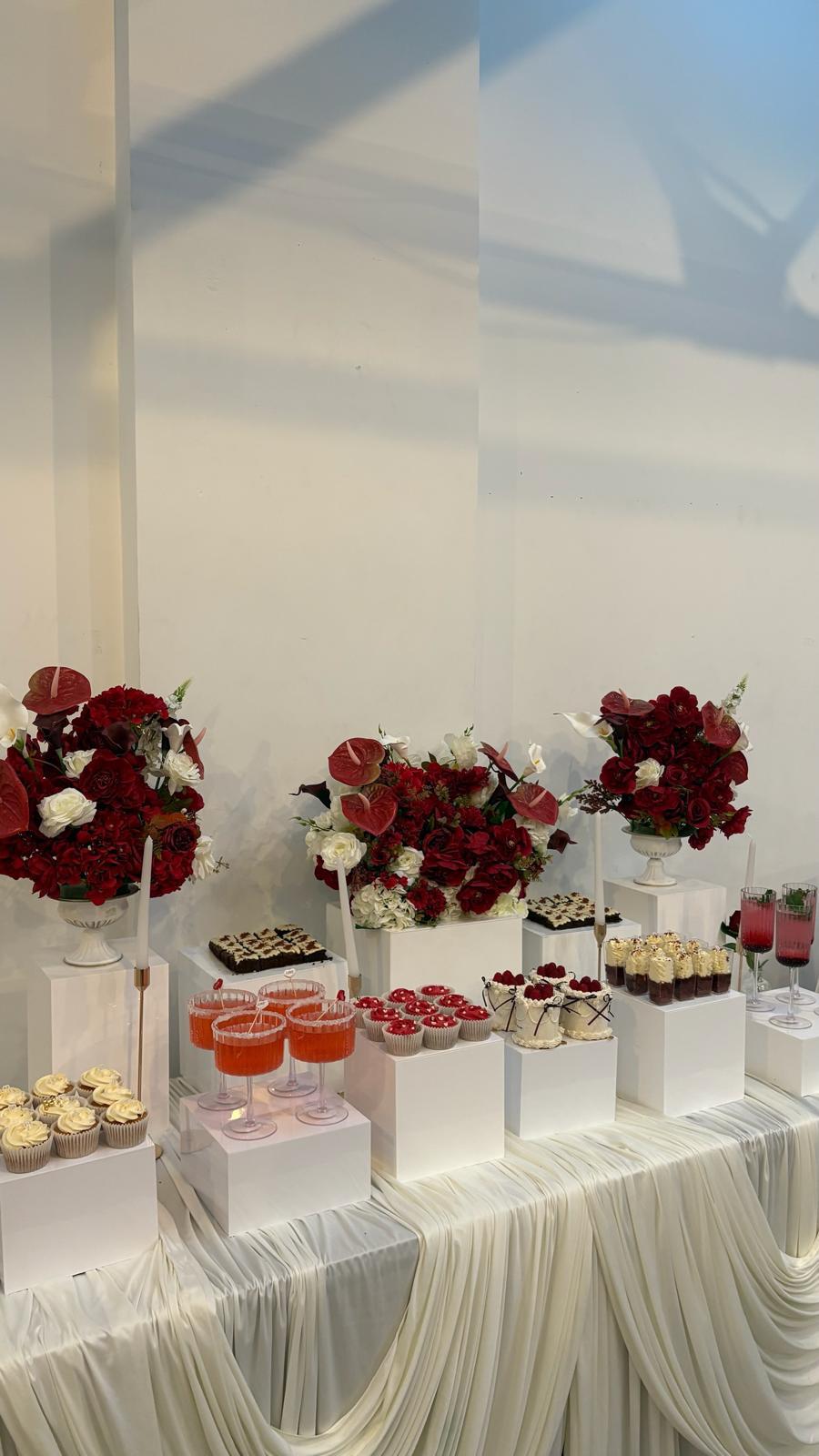 HM Bakes dessert table with floral displays and cupcakes