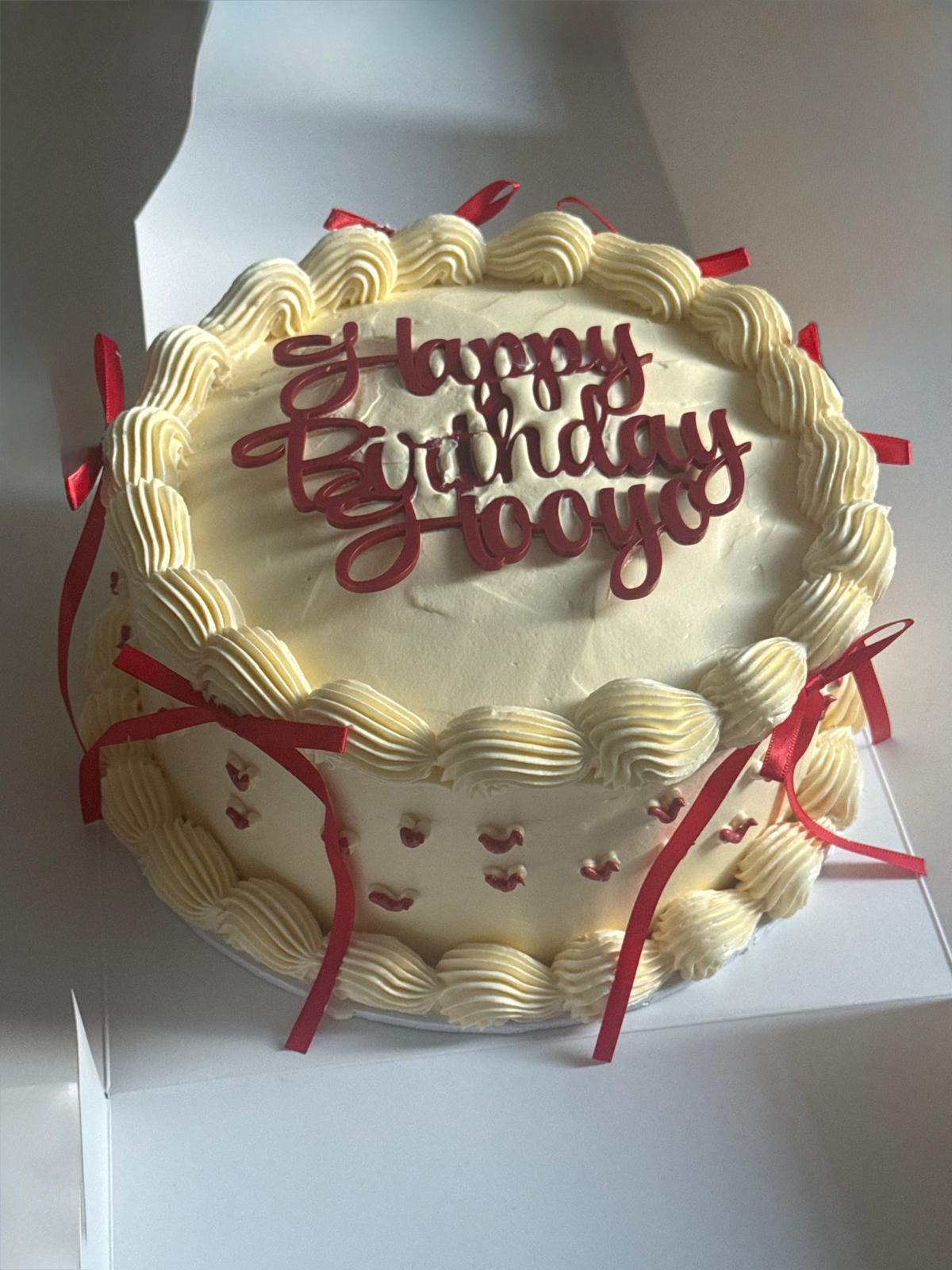 HM Bakes birthday cake with red ribbon detail
