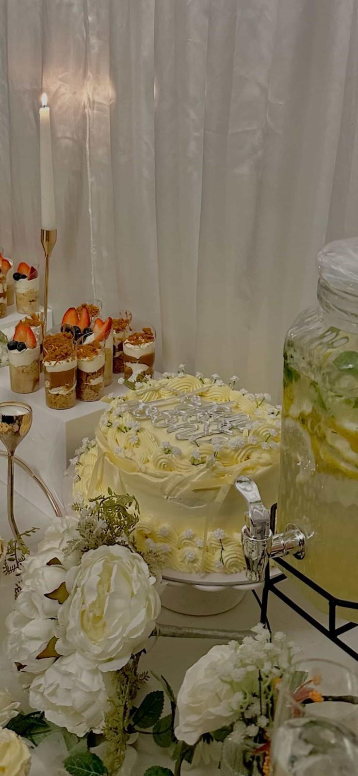 HM Bakes celebration cake with dessert cups and floral styling